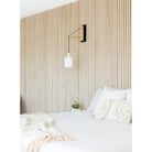 Tumwater 14" Wood Arm Sconce shown in Matte Black with Birch and a Black Hardwired Cord. Interior Design by Naber Design. Photo by Charlotte Lea Photography.