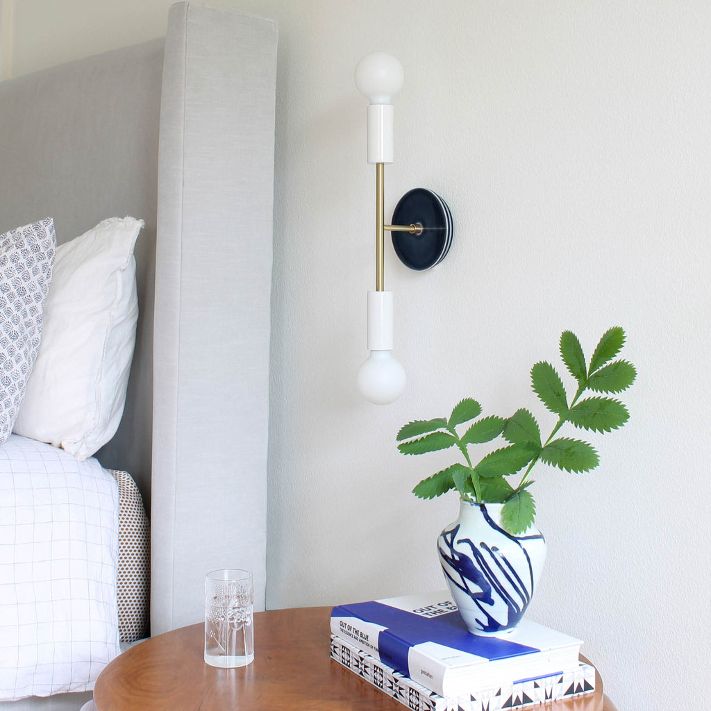 Venus Sconce shown in White with Brass with a Swift pattern  Ceramic canopy in Indigo Blue.