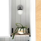    Alto Sconce 6" with Ceramic Canopy shown in Matte Black with a Brownstone White Sunflower Ceramic Canopy Pattern and an Opal 6" globe. Interior Design by Alison Vercruysse