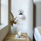 Alto Sconce 6" with Ceramic Canopy shown in Matte Black with a Brownstone White Sunflower Ceramic Canopy Pattern and an Opal 6" globe