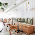 Ramona 8" Wall Sconce shown in Brass with an Opal 8" Glass Globe. Interior Design by Sarah Sherman Samuel