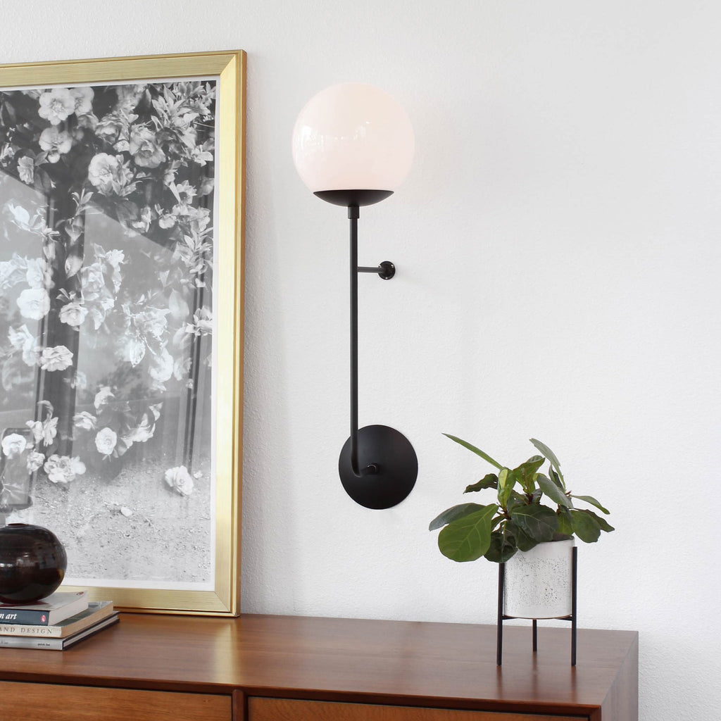 Ramona 8" Wall Sconce shown in Matte Black with an Opal 8" Glass Globe.