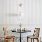 Ramona 8" Wall Sconce shown in Brass with an Opal 8" Glass Globe. Interior Design by Sarah Sherman Samuel