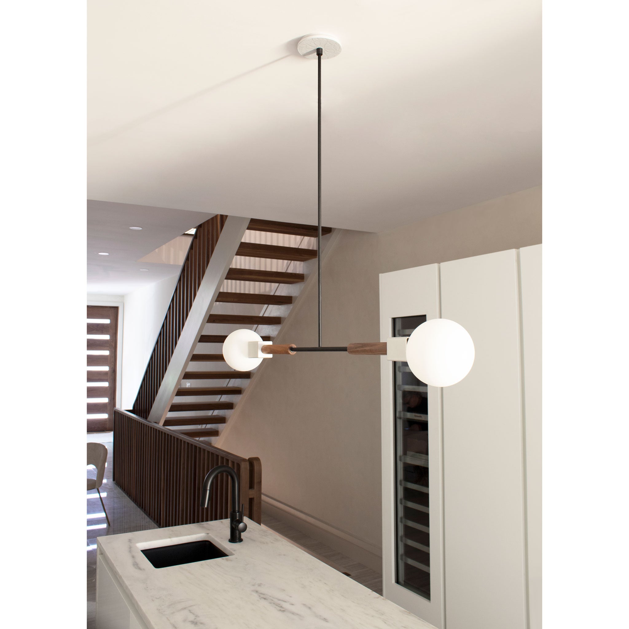 Stanton Pendant shown in Walnut with Swift canopy pattern in Brownstone White Ceramic