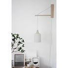 Tumwater 14" Wood Arm Sconce shown in Birch with a White Plug-in Cord. Interior Design by 41 Studios for Parachute Home. Photo by Belle + Whistle Studios.