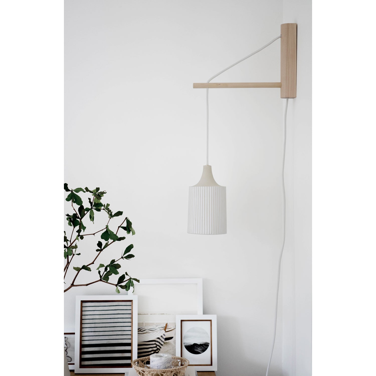 Tumwater 14" Wood Arm Sconce shown in Birch with a White Plug-in Cord. Interior Design by 41 Studios for Parachute Home. Photo by Belle + Whistle Studios.