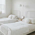 Amélie Sconce 8" shown in White with Brass with a White Twisted Cloth cord. Interior Design by 41 Studios. Photo by Laura Palacios.