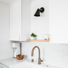 Tilt Cone shown in Matte Black and Brass with a 3" arm. Interior design by Field Theory Design. Photo by Ana Kamin