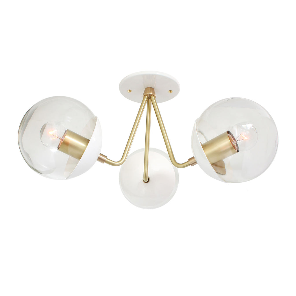 Trillium shown in White with Brass with 6" Clear Globes.
