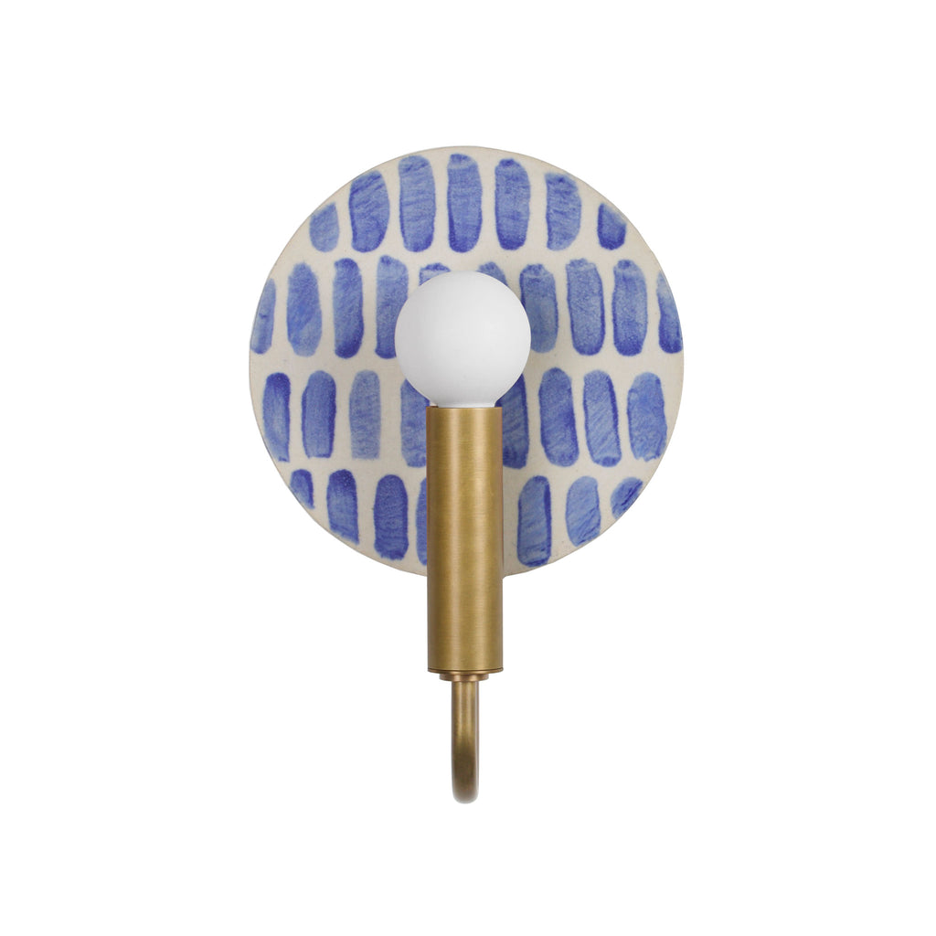 Edith ADA Sconce shown in Heirloom Brass with a Blue Dot Stripe ceramic backplate